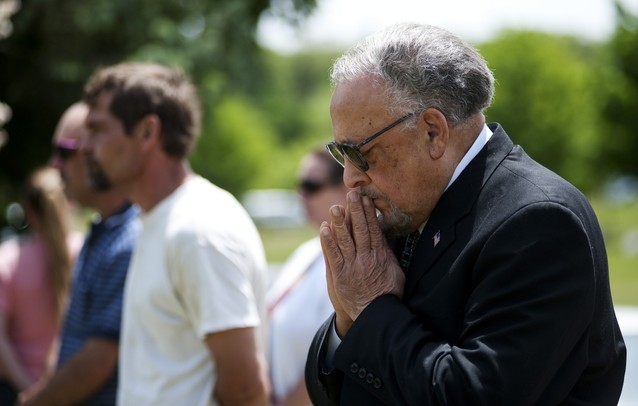 An audience member of the Arborcrest Memorial Day Observance participates in a prayer on Sunday, May 26. Daniel Brenner I AnnArbor.com
